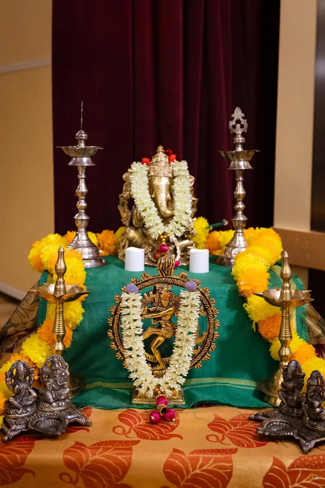 Brass Nataraja — the cosmic dancer — glowing in warm temple light
